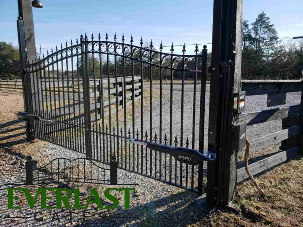 EVERLAST GATES & FENCE automatic wrought iron driveway gate with dual swing openers.