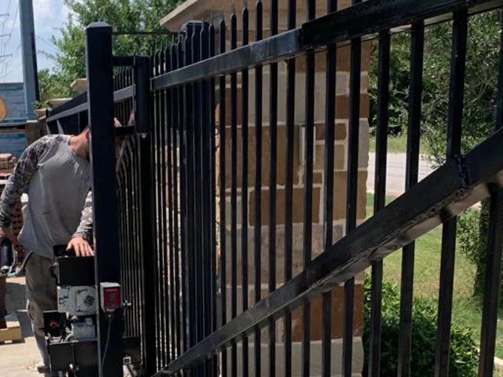 Electric gate technician performing maintenance in Farmers Branch, TX