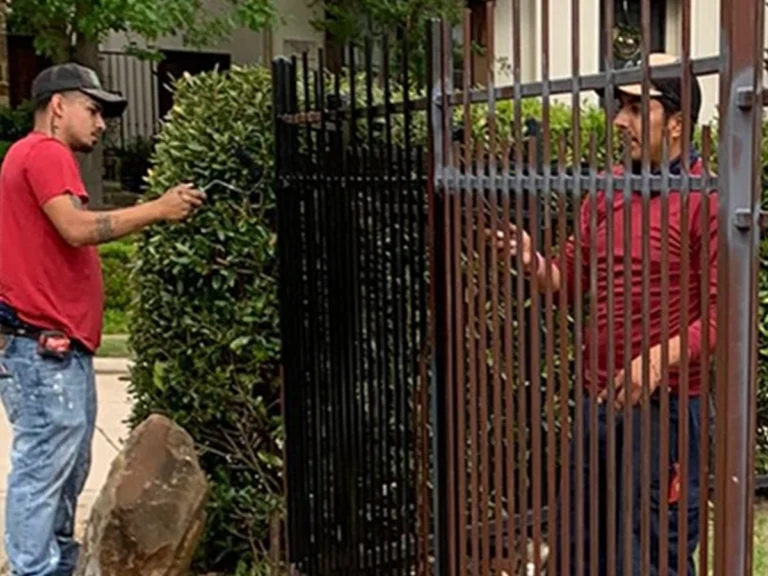 Technician repairing a residential fence gate in Dallas