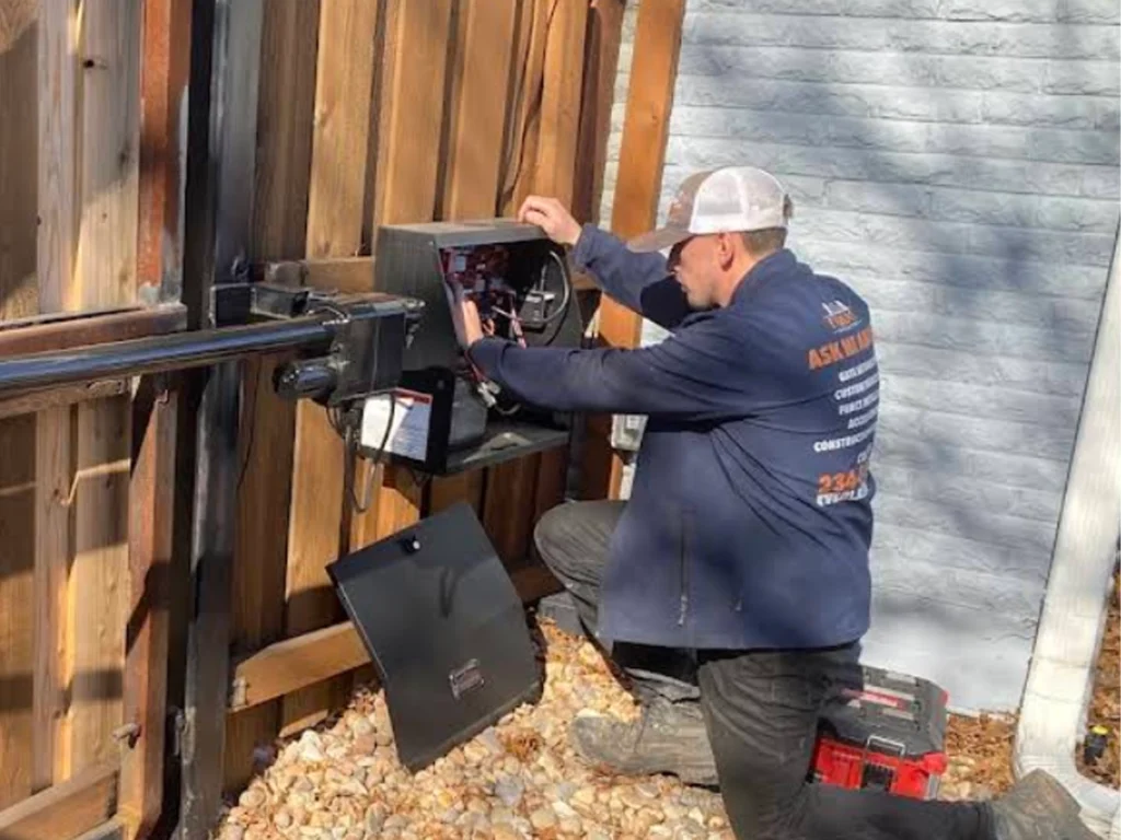 Technicians performing automatic gate repairs in Carrollton, TX for Everlast Gates & Fence.