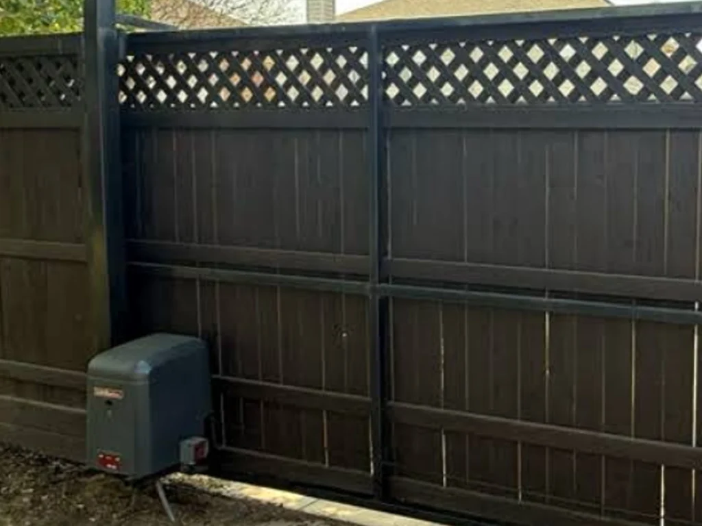 Technician installing an automatic wood gate in Wylie, TX for Everlast Gates & Fence
