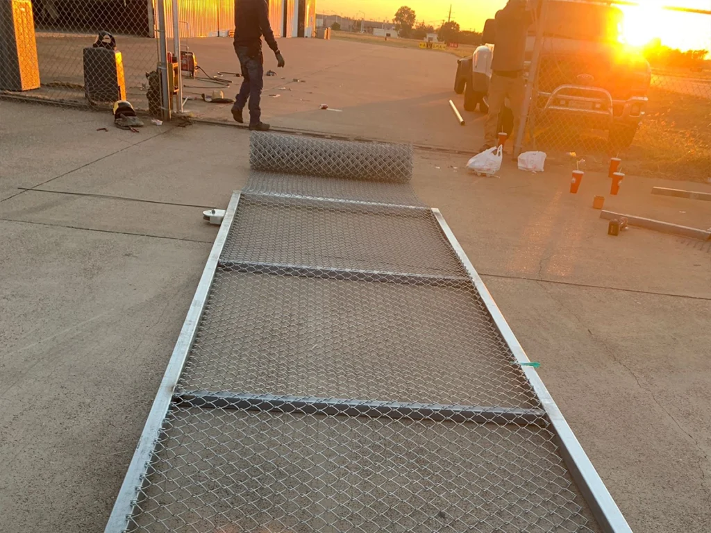 Commercial gate repair in Farmers Branch, showing professionals fixing a malfunctioning gate.