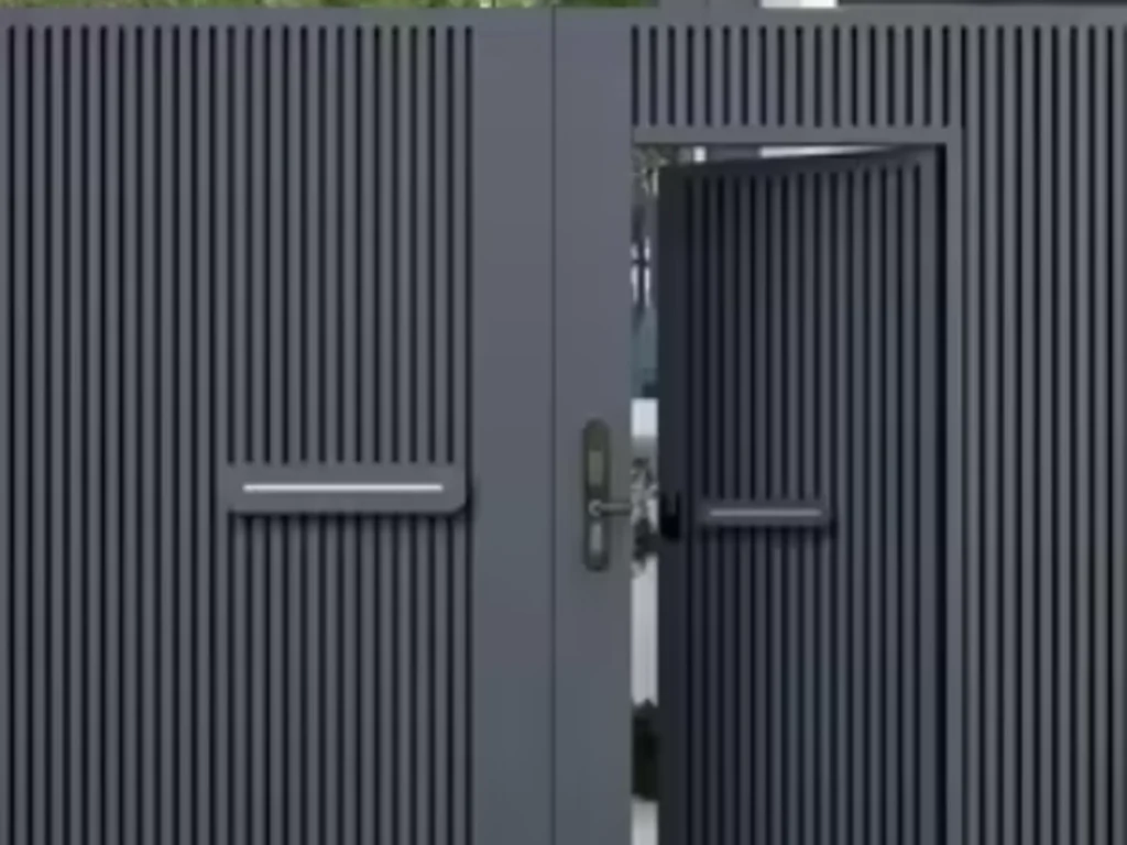 Custom swing gates at a modern Plano property entrance with an integrated intercom and secure driveway access