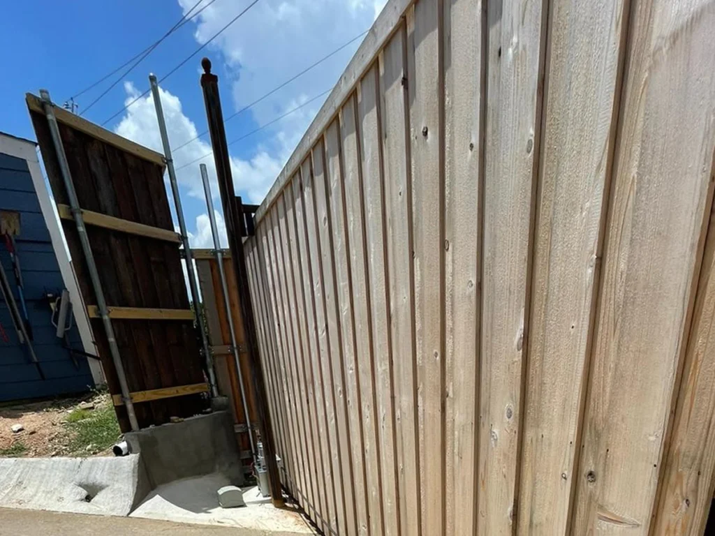 Wood gate installation in Garland by Everlast Gates & Fence.