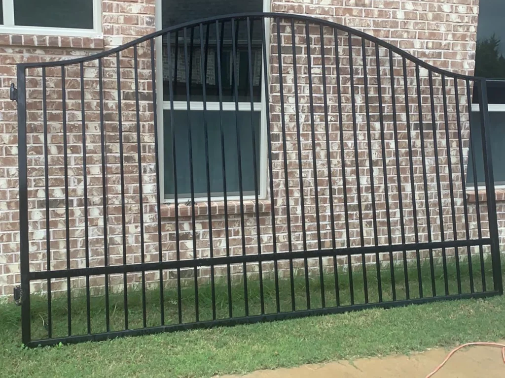 A beautifully designed custom wrought iron gate installed in front of a home in Carrollton, TX.