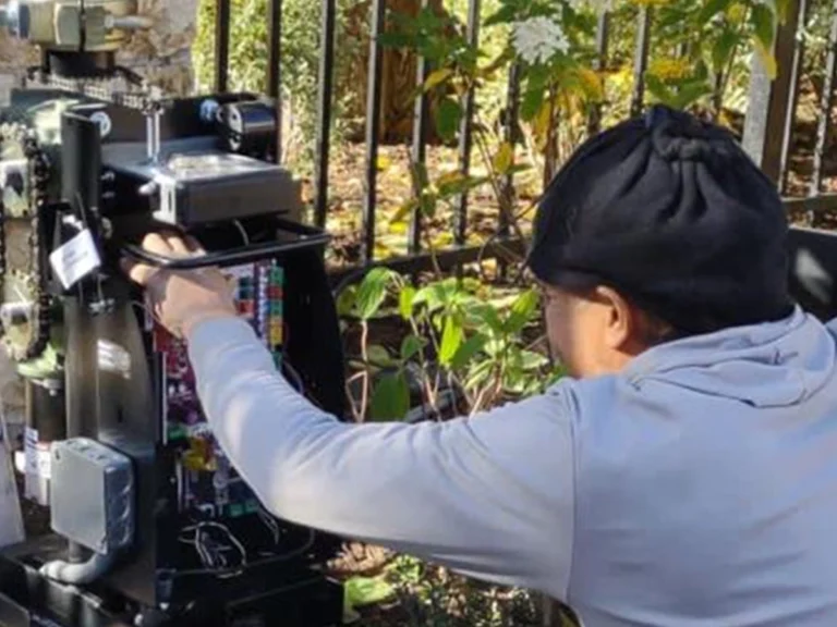 Technician from Everlast Gates & Fence servicing an electric gate in Dallas