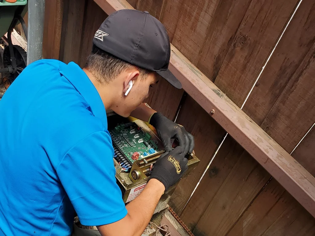 A homeowner performing maintenance on their electric gate in Wylie, TX.