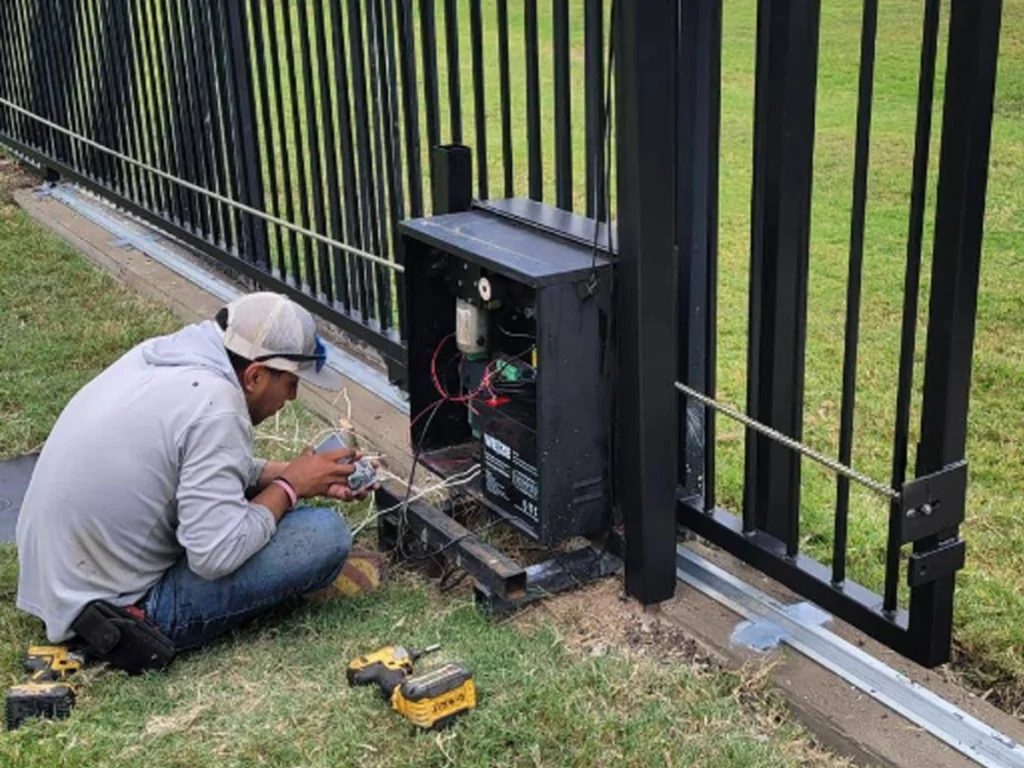 Technician performing electric gate troubleshooting in Dallas property