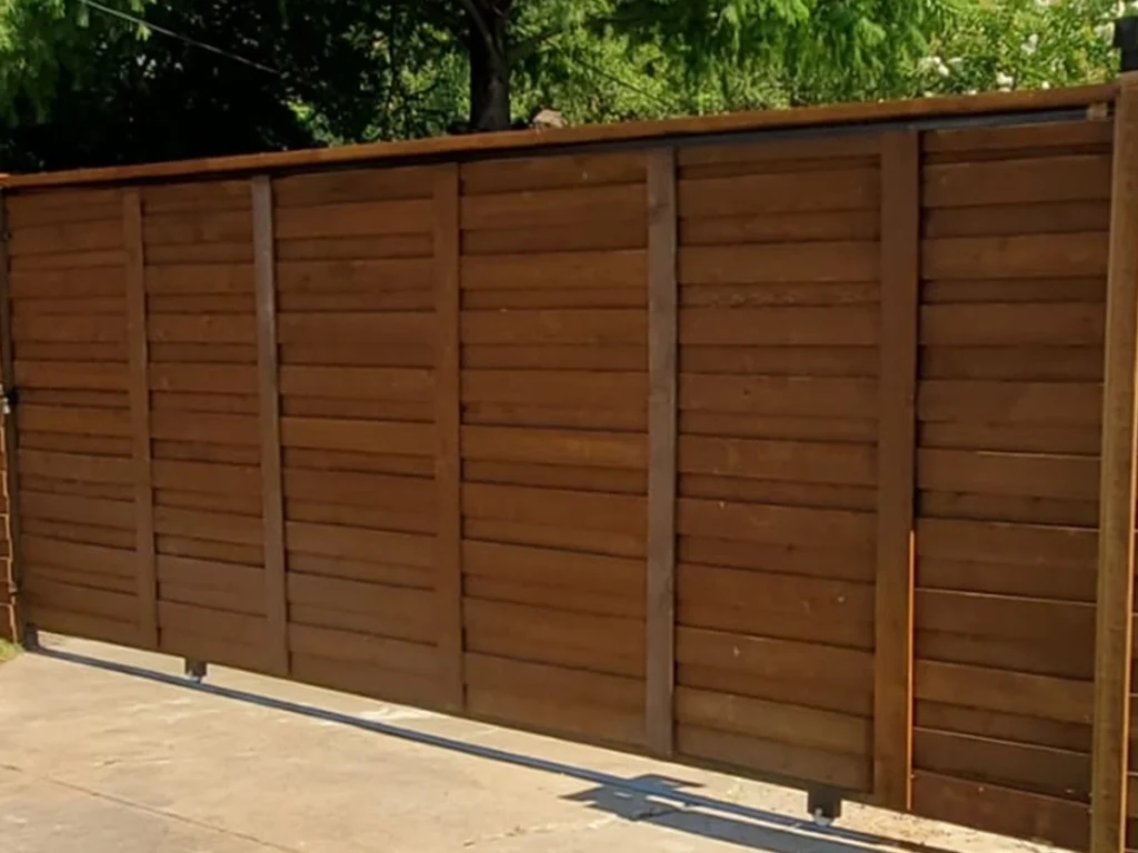 Elegant wood sliding gate installed by Everlast Gates & Fence in a Houston home