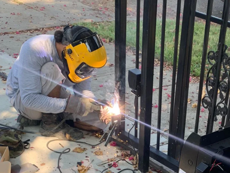 Technician fixing a sliding gate in Farmers Branch during an emergency repair by Everlast Gates & Fence