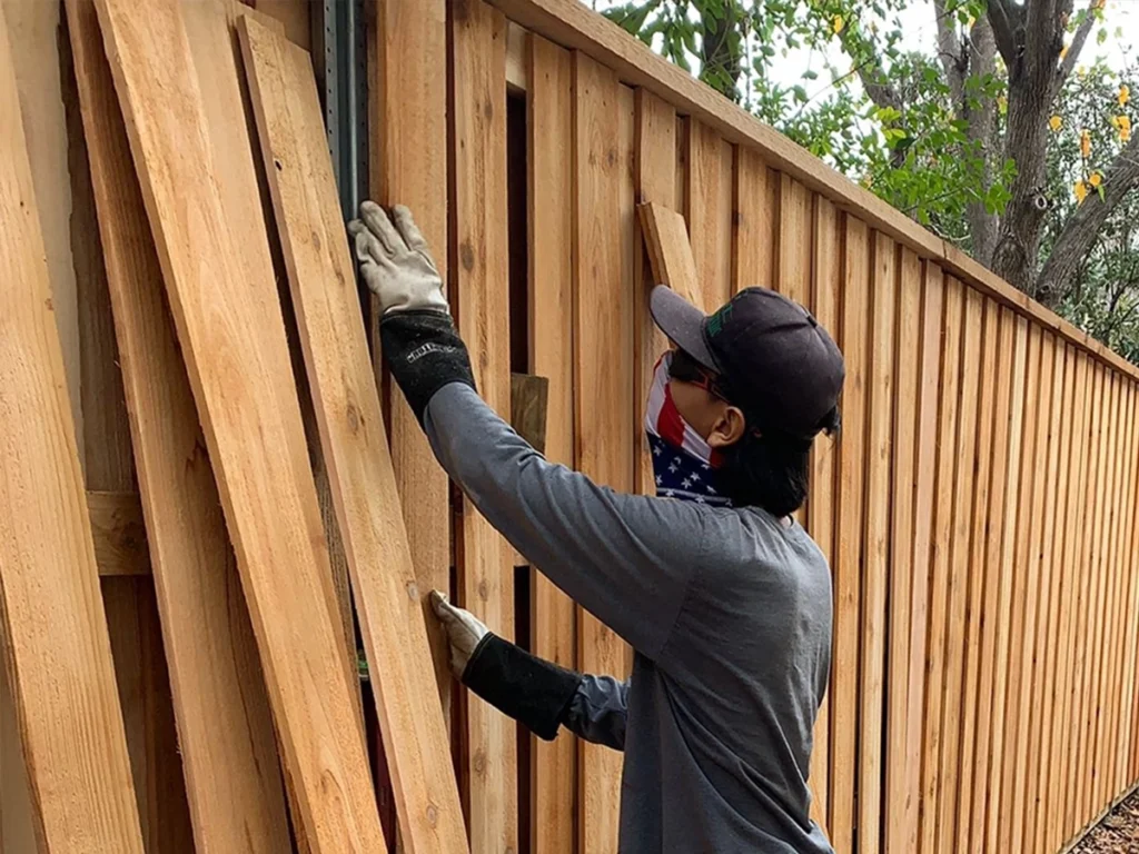 Fence repair professionals from Everlast Gates & Fence fixing damaged wooden panels