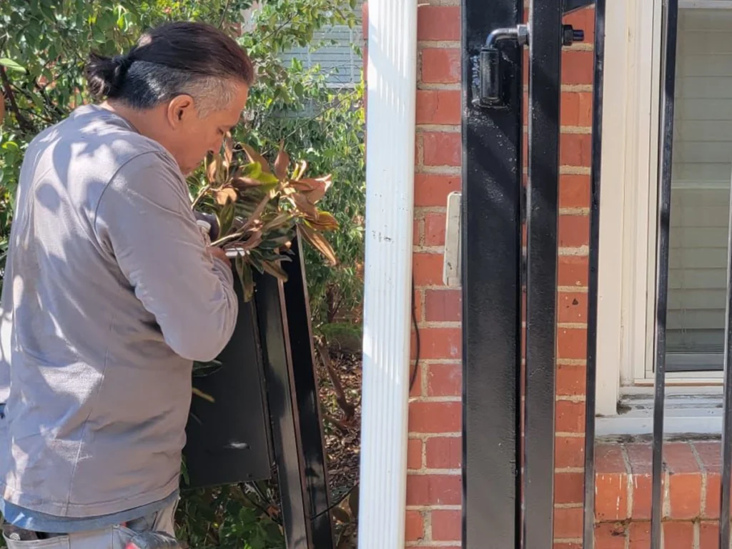 Technician performing gate maintenance in Carrollton, Texas