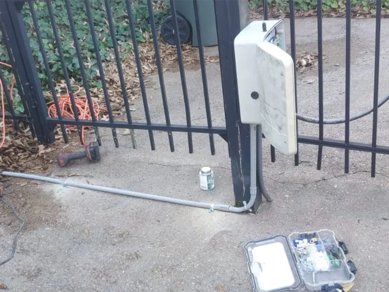 Technician repairing automatic gate in Southlake, TX for Everlast Gates & Fence
