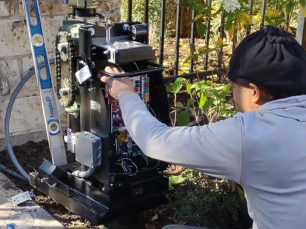 Houston gate damaged by extreme heat with Everlast technician diagnosing