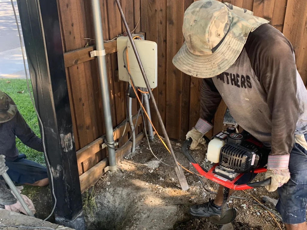 Gate maintenance expert working on a residential gate in Carrollton’s humid climate