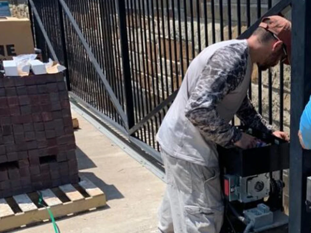 Technician performing residential gate repair in Dallas for Everlast Gates & Fence