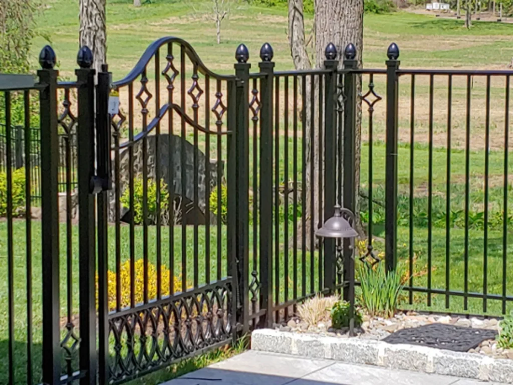 Iron fence gate Wylie home with custom design that matches brick exterior