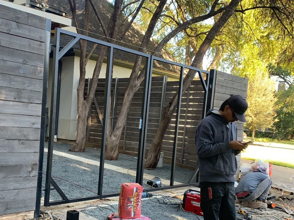 Homeowner fixing a gate to avoid common maintenance mistakes in Farmers Branch