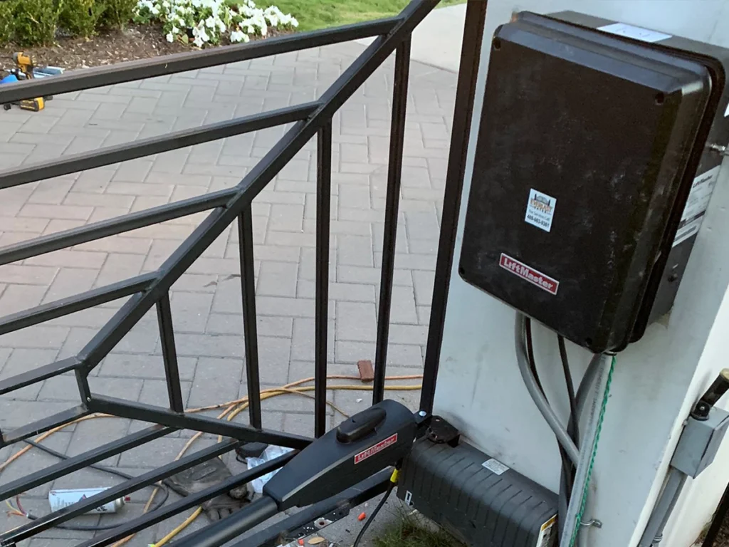 Electric gate repair technician fixing a malfunctioning gate in Fort Worth.