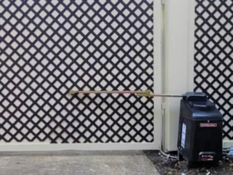 Technician performing professional electric gate repair at a home in Richardson