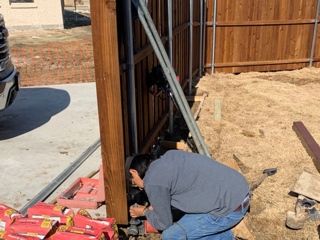 Technician repairing a metal gate at a residential Wylie property