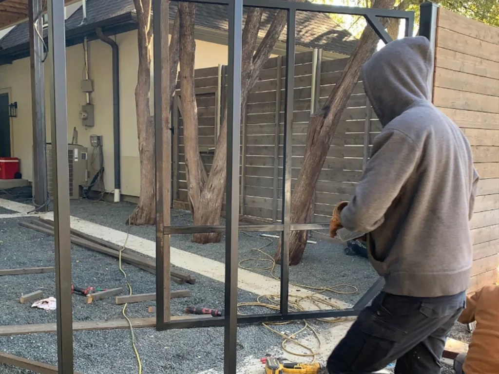 Stuck iron gate being repaired by a professional technician in Farmers Branch, TX.