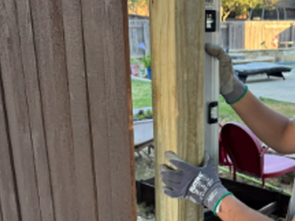 Wooden fence repair techniques showing post reinforcement and picket replacement in Farmers Branch