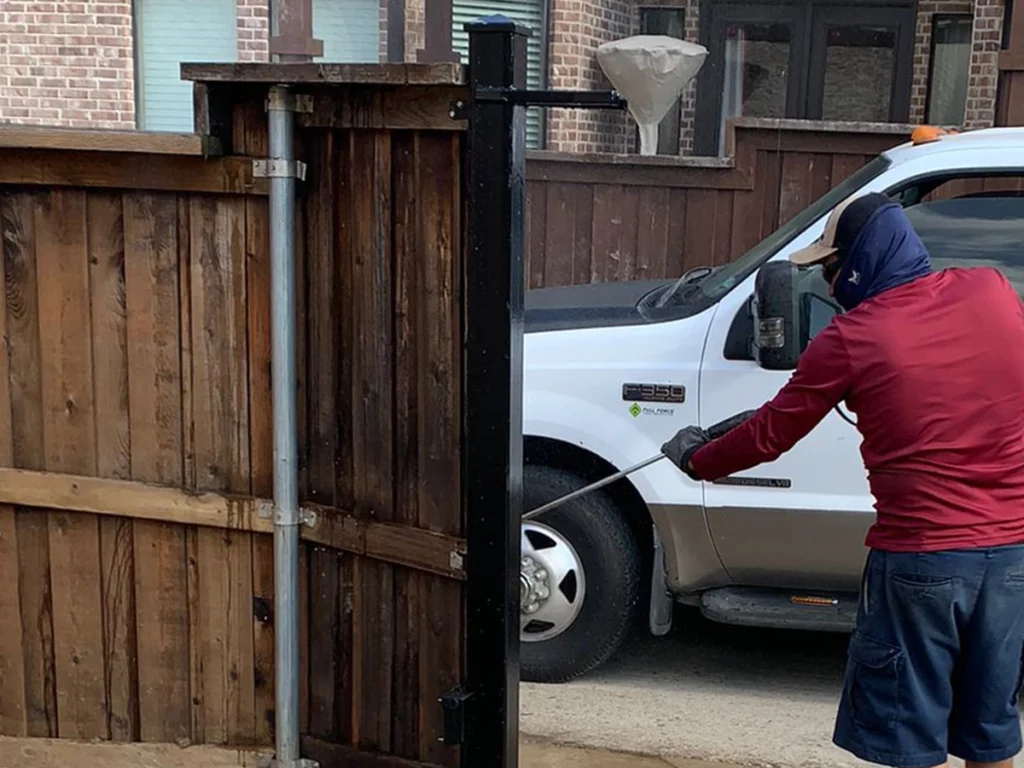 Technician repairing a residential gate in Frisco, TX