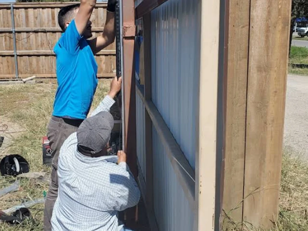 Technician performing seasonal care for a call entry gate in Dallas