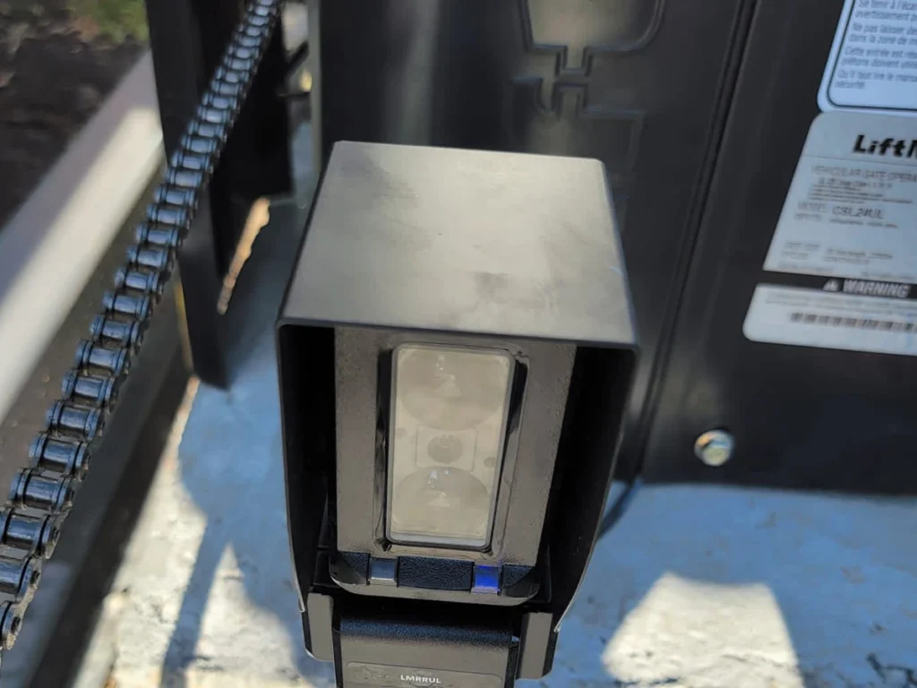 Technician performing seasonal electric gate maintenance in Dallas