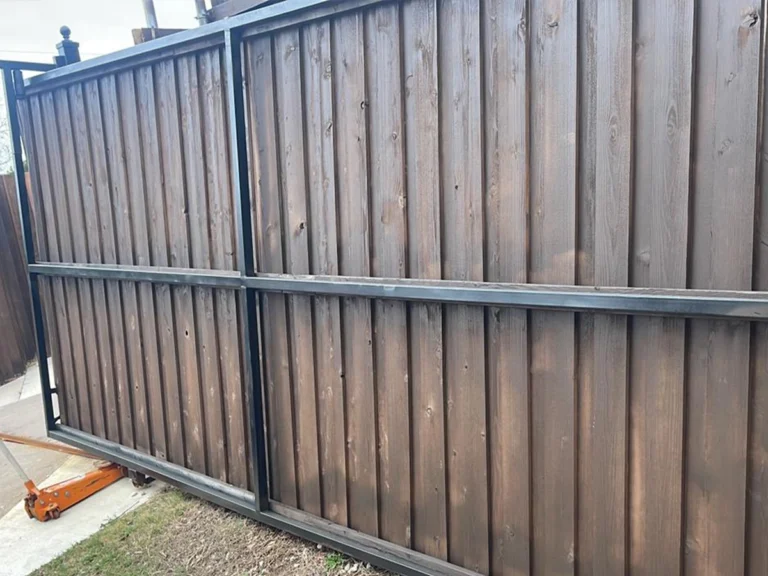 Technicians installing a modern sliding gate in Garland for a residential property