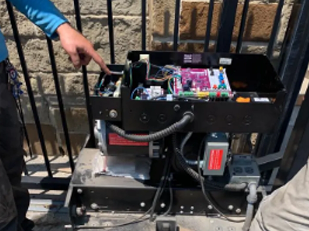 schedule sliding gate maintenance inspection in Fort Worth with technician checking rollers and track