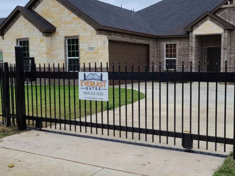 Technician repairing a sliding gate in Garland, TX with Everlast Gates & Fence