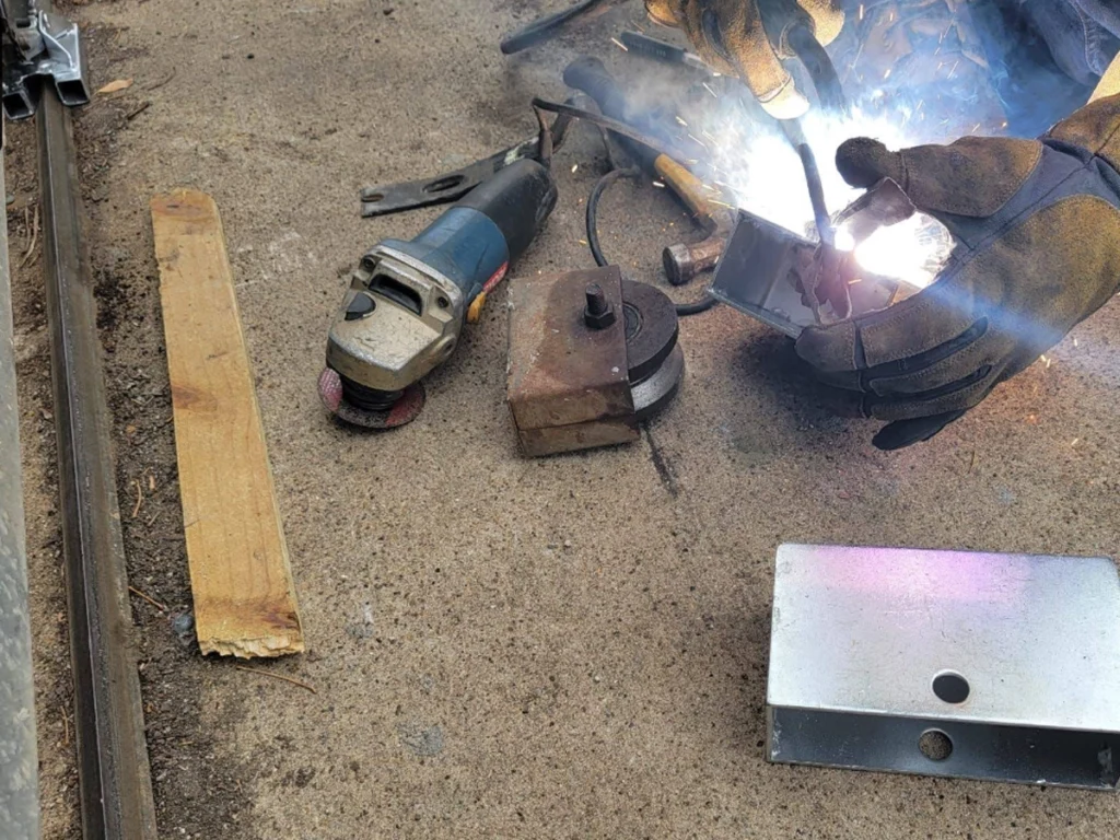 Technician inspecting a sliding gate for repair in Farmers Branch