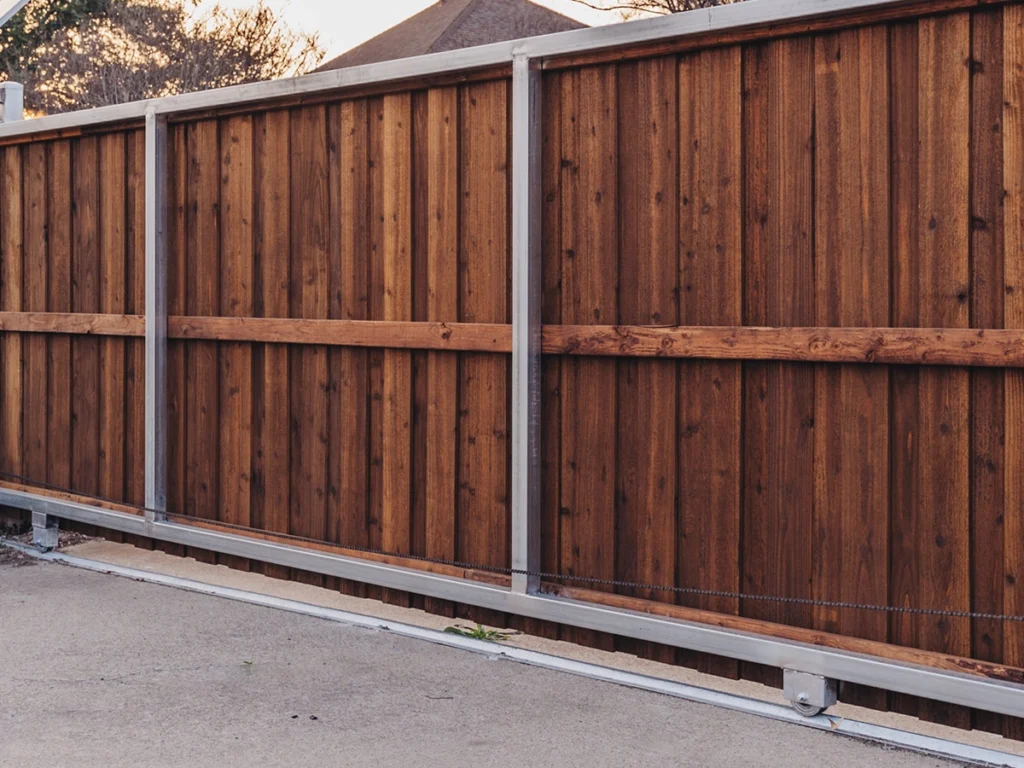 Technician upgrading a modern sliding gate in Garland, Texas