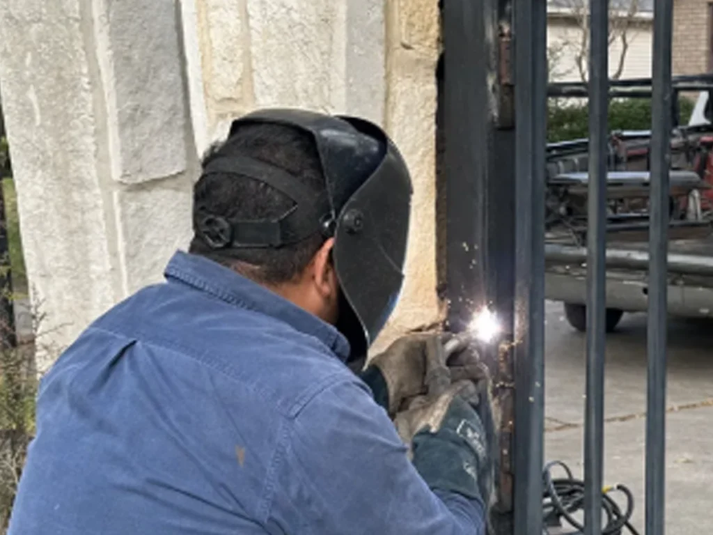 Steel gate welding repair restoring structural strength and security in a Dallas residential driveway