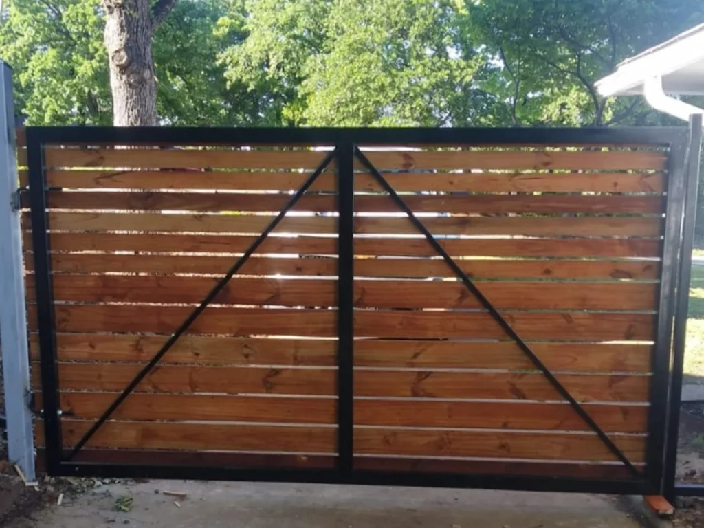 Custom wood gate installation in Farmers Branch by Everlast Gates & Fence.