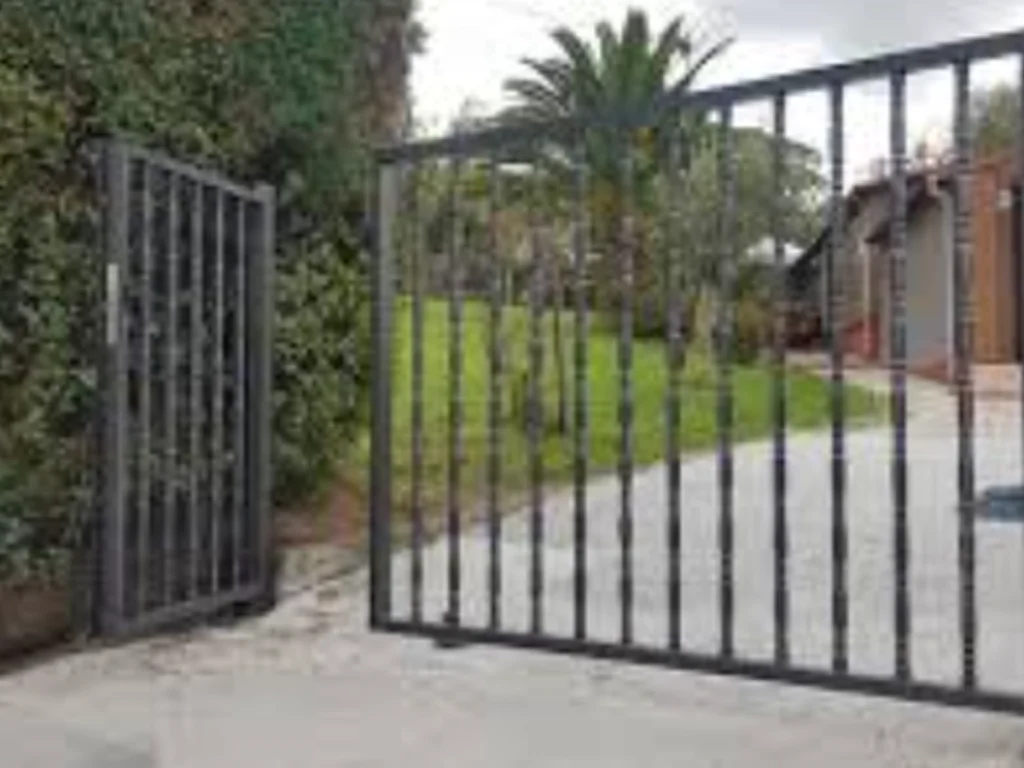 swing gate installation Plano modern swing gate with secure access control at a driveway entrance