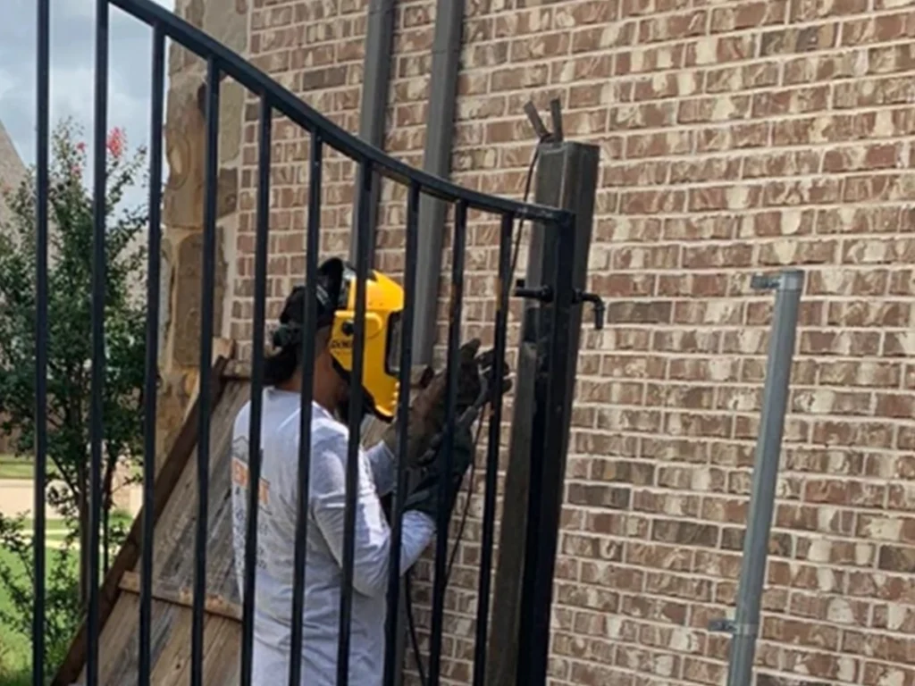 Welder at Everlast Gates & Fence reinforcing a custom gate in Dallas