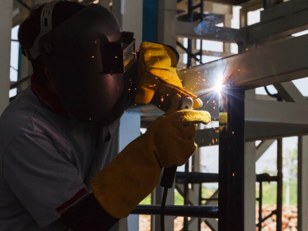 Technician welding a broken residential gate in Carrollton, TX