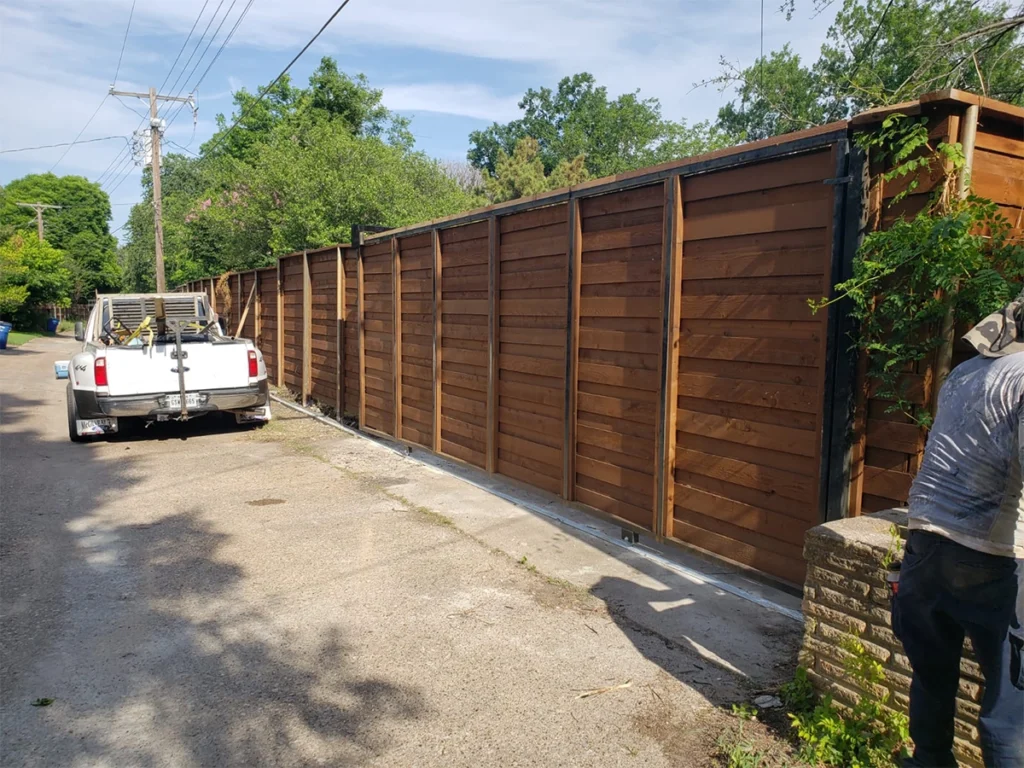 Plano, TX lake wood fence with sunlight highlighting its smooth, well-maintained surface