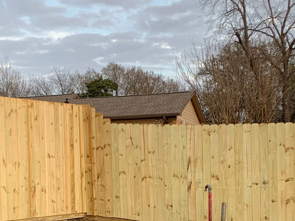 Wood fence surrounding a home in Carrollton, TX, showcasing natural beauty and durability