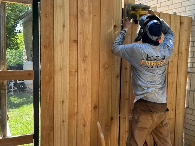 Wood gate installation in Carrollton by Everlast Gates & Fence