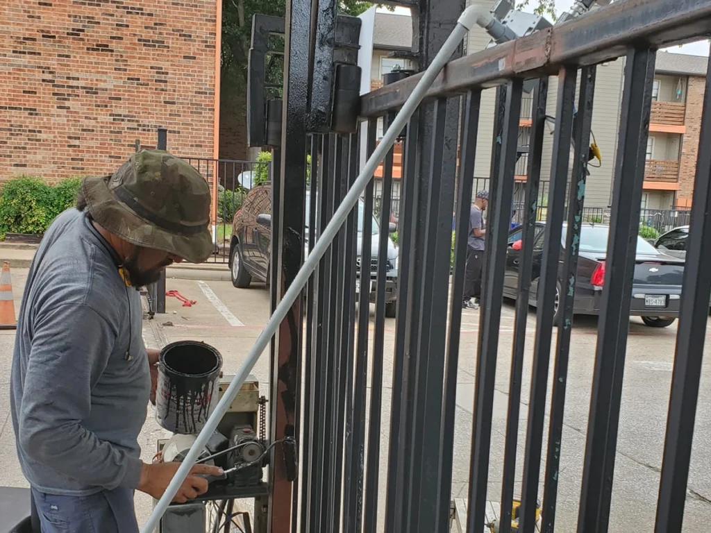 Expert repairing a rusted metal gate at Everlast Gates & Fence